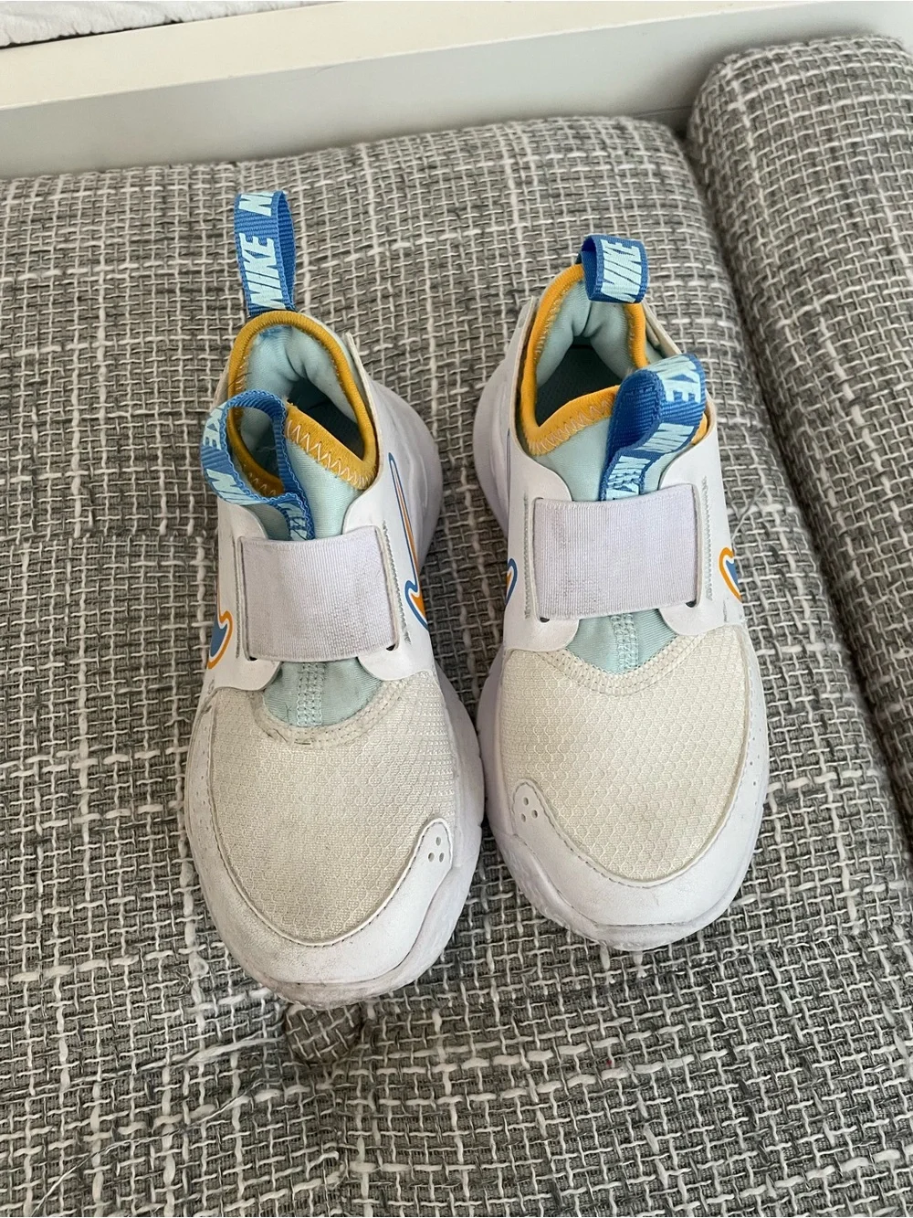 Nike Kids White Sneakers with Blue and Yellow Accents
